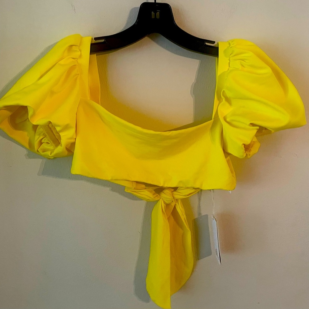 Women’s bikini top. Puff sleeves and ties in back. New with tags. Size medium